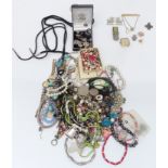 A collection of costume jewellery including beads, brooches, necklaces including Navajo, silver