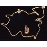 A 9ct gold necklace and an Edwardian 9ct gold kidney bean shaped charm set with a ruby, 3.4g