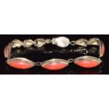 A 14k gold bracelet set with marquise cut coral cabochons, 8g