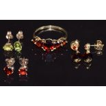 A 9ct gold ring set with garnets, two pairs of 9ct gold earrings set with garnets and a pair of