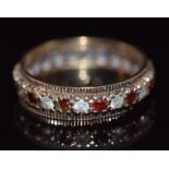 A 9ct gold eternity ring set with alternating paste and garnets, 3.5g, size O