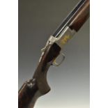 Browning Citori 12 bore over and under shotgun with gold engraving of birds and dogs surrounded by