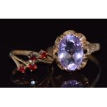 A 9ct gold ring set with an oval cut amethyst and a 9ct gold ring set with garnets, 5.4g, sizes K