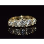 An 18ct gold ring set with five old cut diamonds measuring 0.65, 0.45, 0.45, 0.3ct & 0.3ct