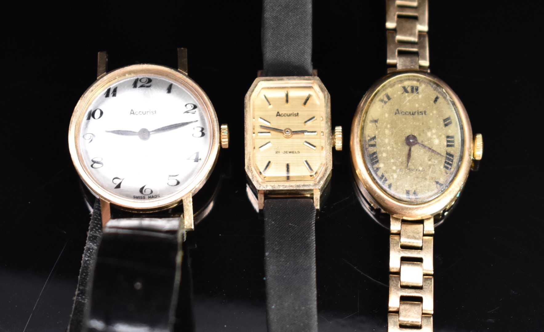 Three Accurist 9ct gold ladies wristwatches, one on yellow metal bracelet the others on black