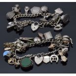 Two silver charm bracelets with over 29 charms including enamel clover, St Christopher, shell,