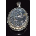 A Victorian silver locket with engraved bamboo and bird decoration verso floral decoration, 4 x 3.