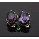 A pair of silver earrings set with foiled amethysts by Russell Sam and a loose 0.3ct oval cut