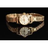 Omega 9ct gold ladies wristwatch with black hands, gold baton markers, silver dial and signed 17