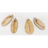 Four fossilised fish pendants