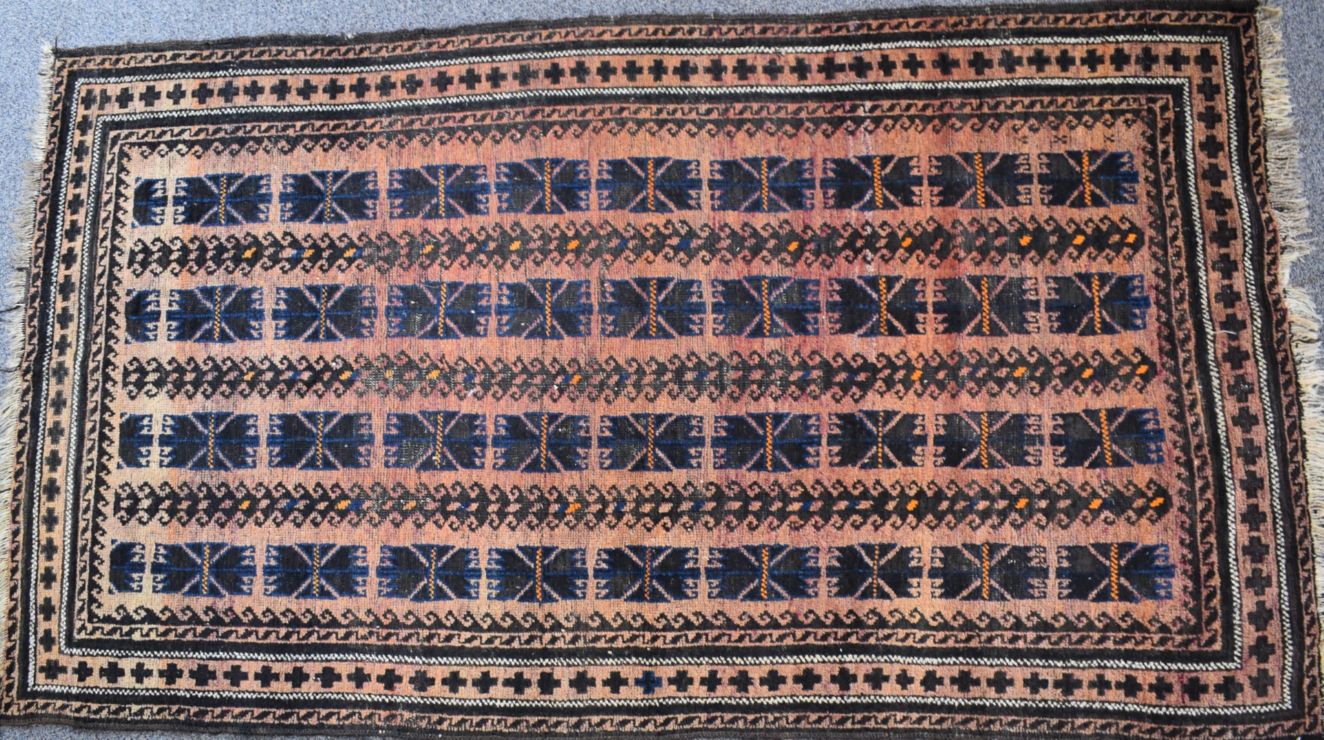 Turkoman rug with four rows of nine guls on a wine ground, 197 x 111cm