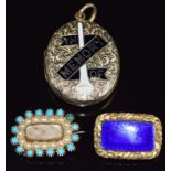 An early 20thC mourning locket with engraved floral decoration set with enamel reading 'In Memory