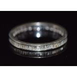 A 10k gold eternity ring set with baguette cut diamonds, 1.4g, size N