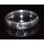 A platinum ring set with a round cut diamond of approximately 0.25ct, 9.3g, size I/J