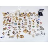 A collection of vintage brooches including silver, diamanté, enamel, etc