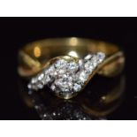 An 18ct gold ring set with round cut diamonds in a twist setting, size N, 5.2g