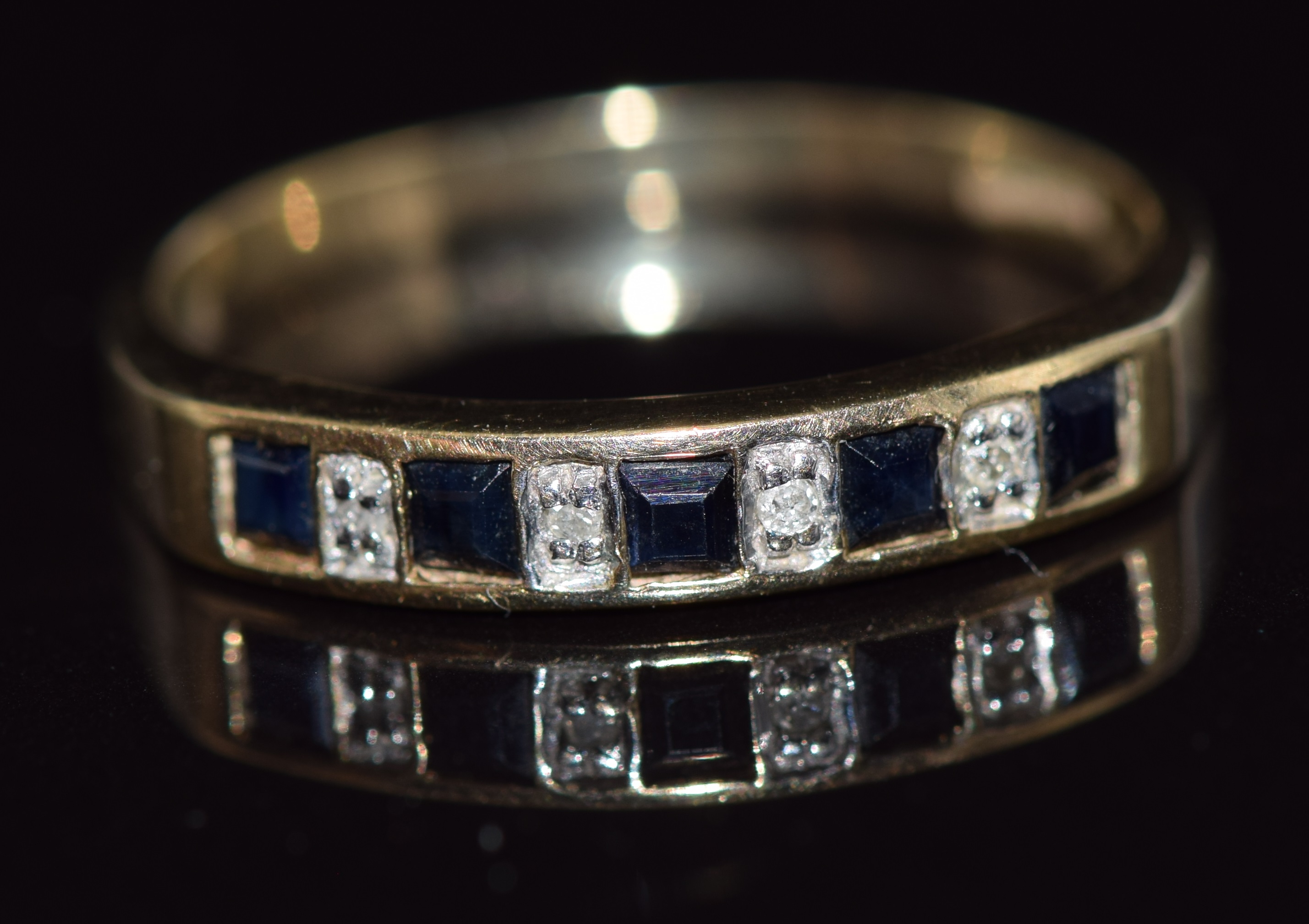 A 9ct gold ring set with alternating sapphires and diamonds, 1.9g, size P