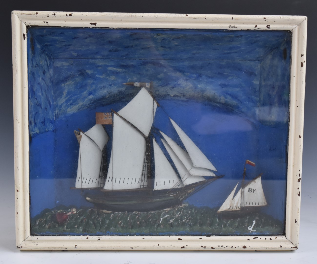 A 19thC diorama of two sailing ships, probably painted metal, in glazed case, 31x38cm