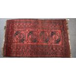 Turkoman rug with four guls on a wine ground, 196 x 116cm