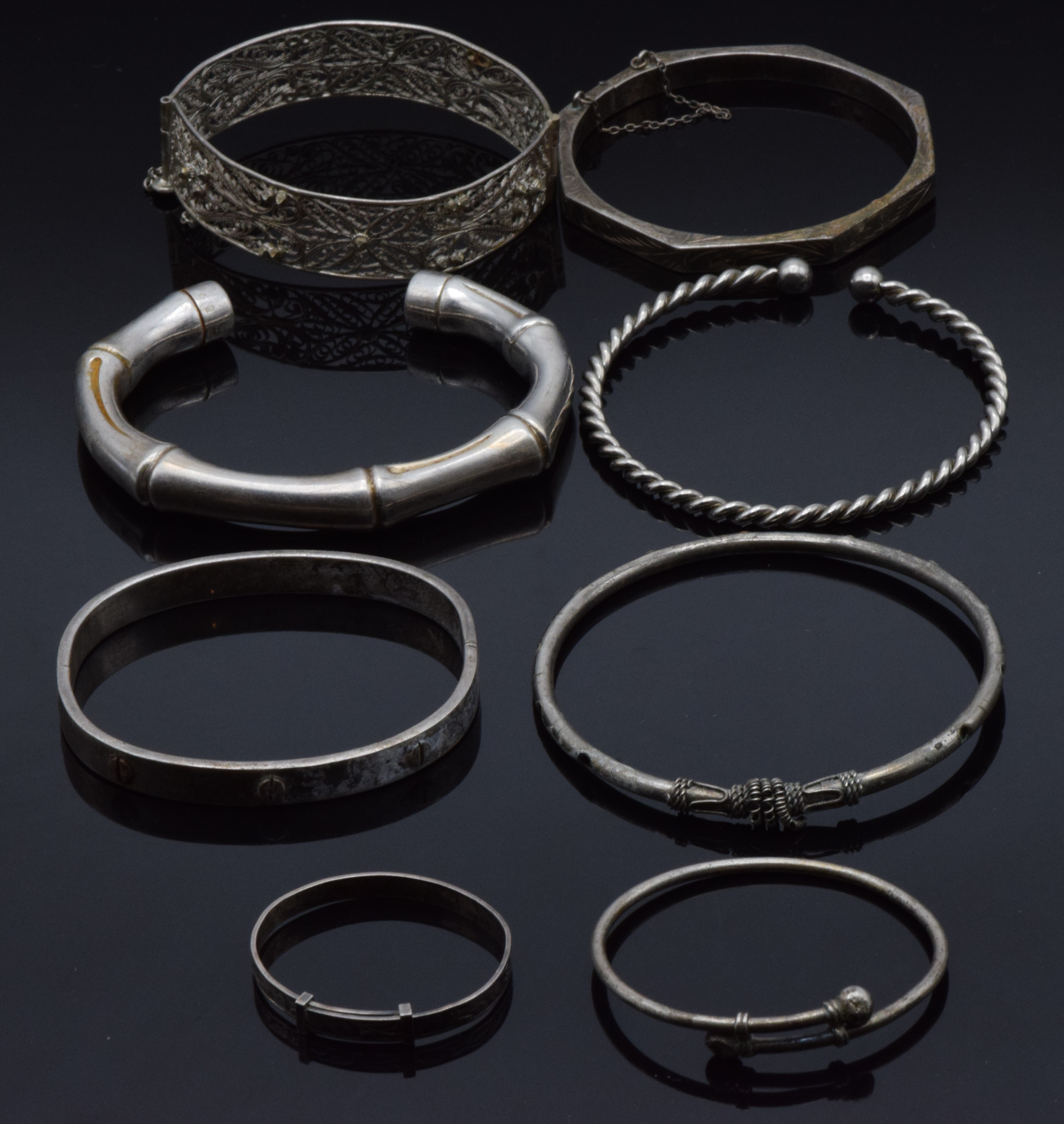 Four silver bangles, two christening bangles and a filigree bangle