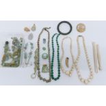 A nephrite jade bangle, quartz beads, ivory beaded necklaces, etc