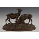 Cast metal model of a pair of deer on naturalistic oval base, L20cm