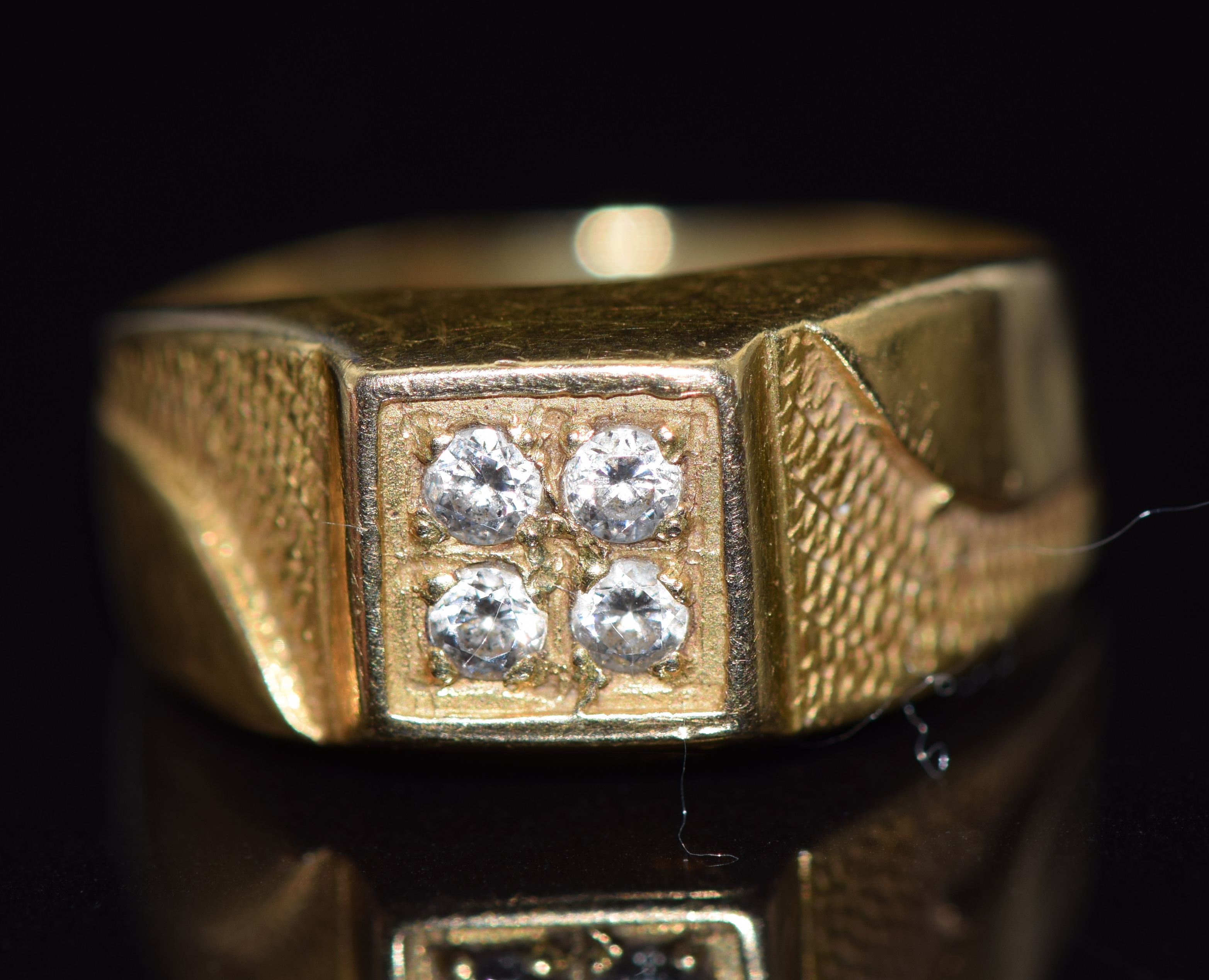 A yellow metal ring set with four diamonds, 3.7g, size I