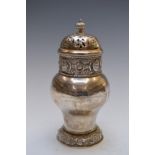 George V Arts and Crafts hallmarked silver sugar caster with pierced cover, embossed lion mask