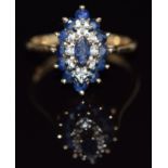 A 9ct gold ring set with diamonds and sapphires in a marquise shaped setting, 2.8g, size K/L