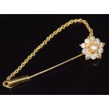 An 18ct gold stick pin set with a pearl surrounded by diamonds, 2.1g, 3.6cm long