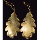 A pair of 14ct gold earrings in the form of an oak leaf with textured decoration, 14g