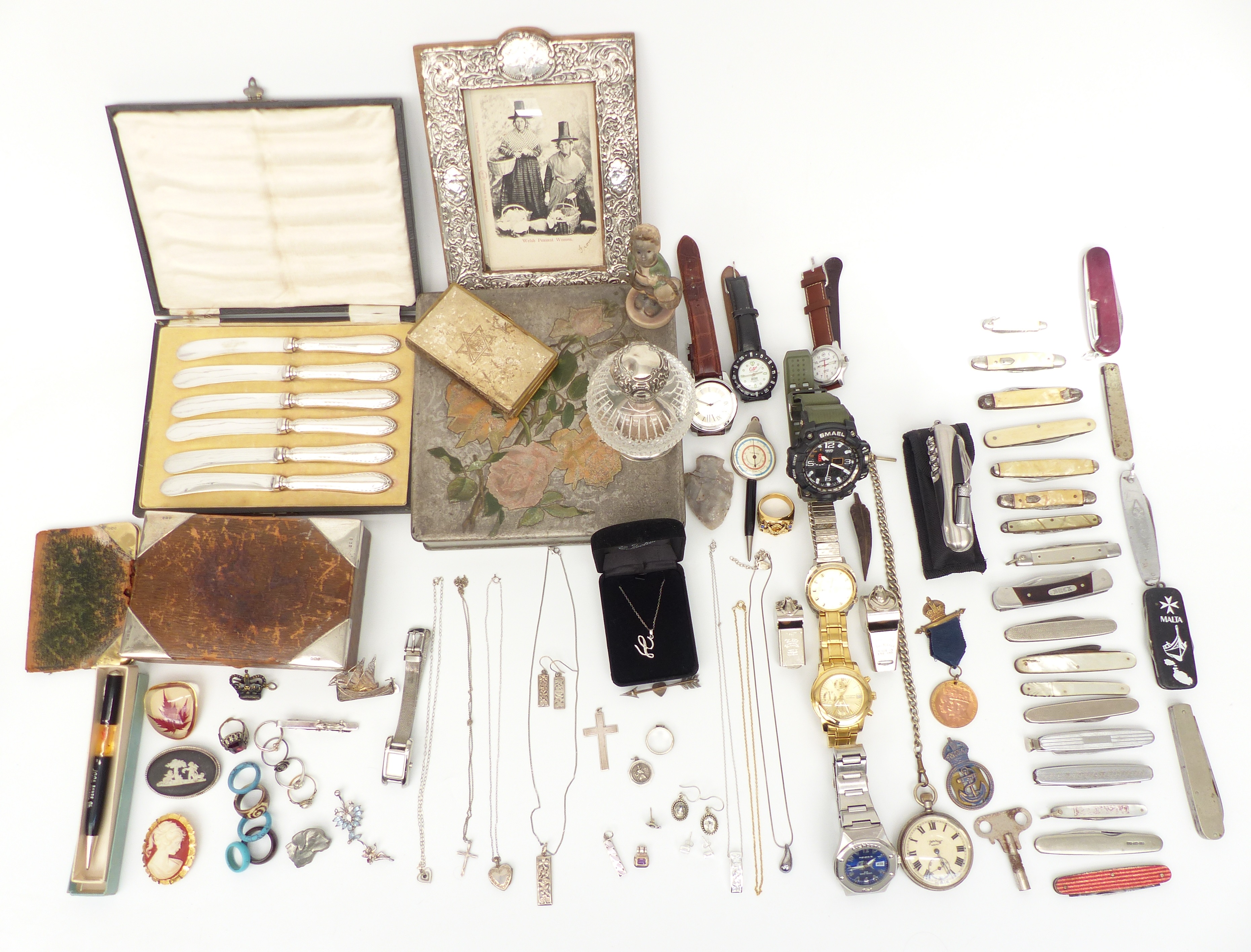 A collection of costume jewellery including brooches, silver topped bottle, silver edged