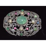 A continental silver brooch set with emerald cabochon, ruby cabochons and sapphires and four pearls,