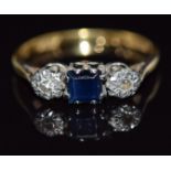 An 18ct gold ring set with a square cut sapphire and diamonds in platinum setting, 2.4g, size K