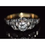 An 18ct gold ring set with a round cut diamond of approximately 0.3ct in a platinum setting, 3.1g,