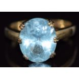 A 9ct gold ring set with an oval cut blue topaz, size N