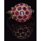 A 9ct gold ring set with a cluster of round cut rubies, 3.1g, size O