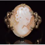 A 9ct gold ring set with a cameo with bow decoration to the shoulders, 2.7g, size N