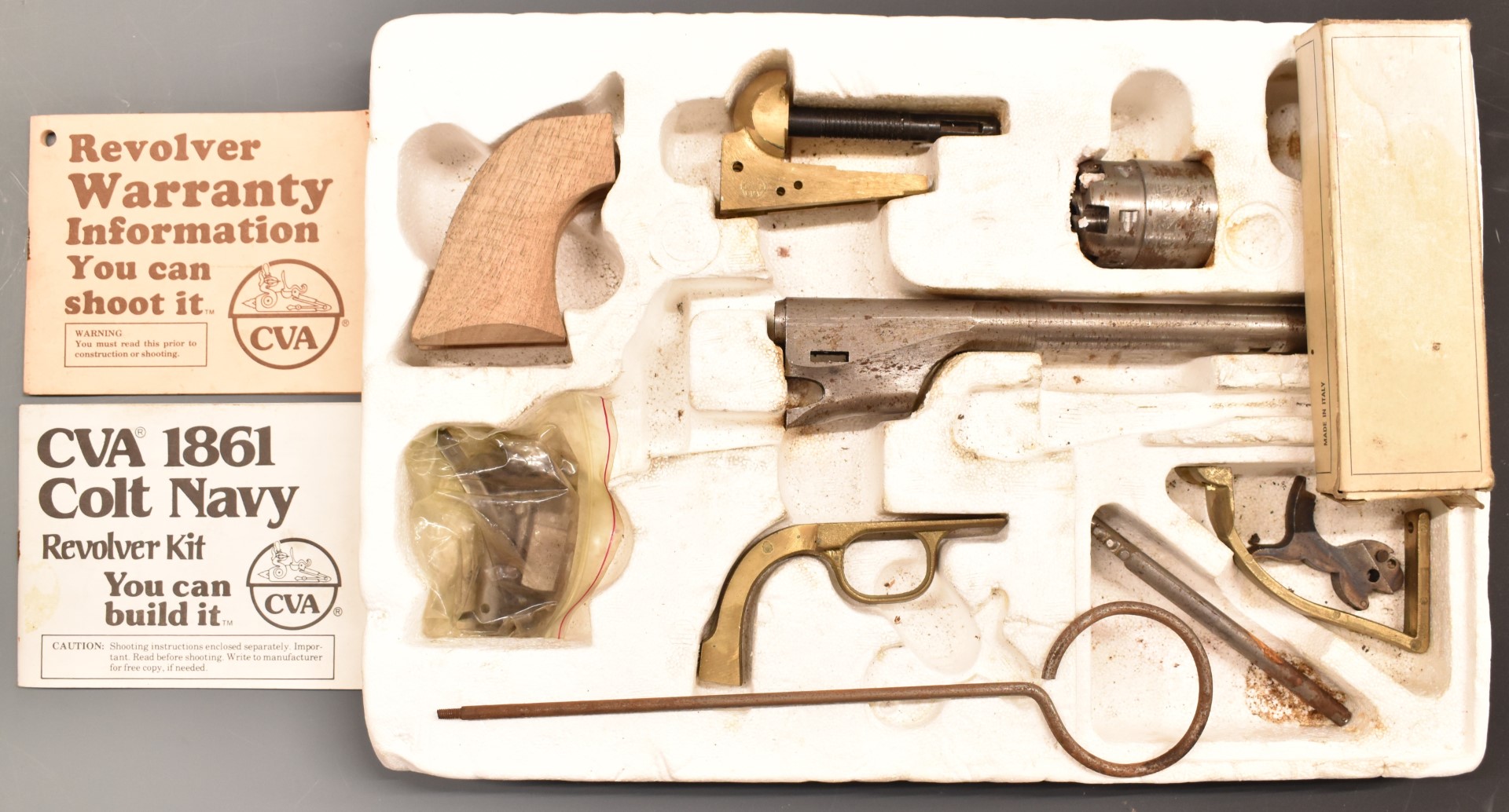 CVA model Colt Navy 1861 revolver kit with brass frame, wooden grips, engraved scene of ships to the