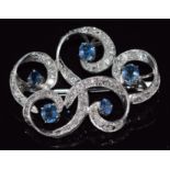 A white gold brooch set with oval cut sapphire and diamonds, 3.8 x 2.8cm, 8.6g