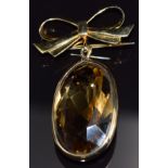 A 9ct gold bow brooch set with a large oval cut citrine, 14.4g, 5 x 3cm