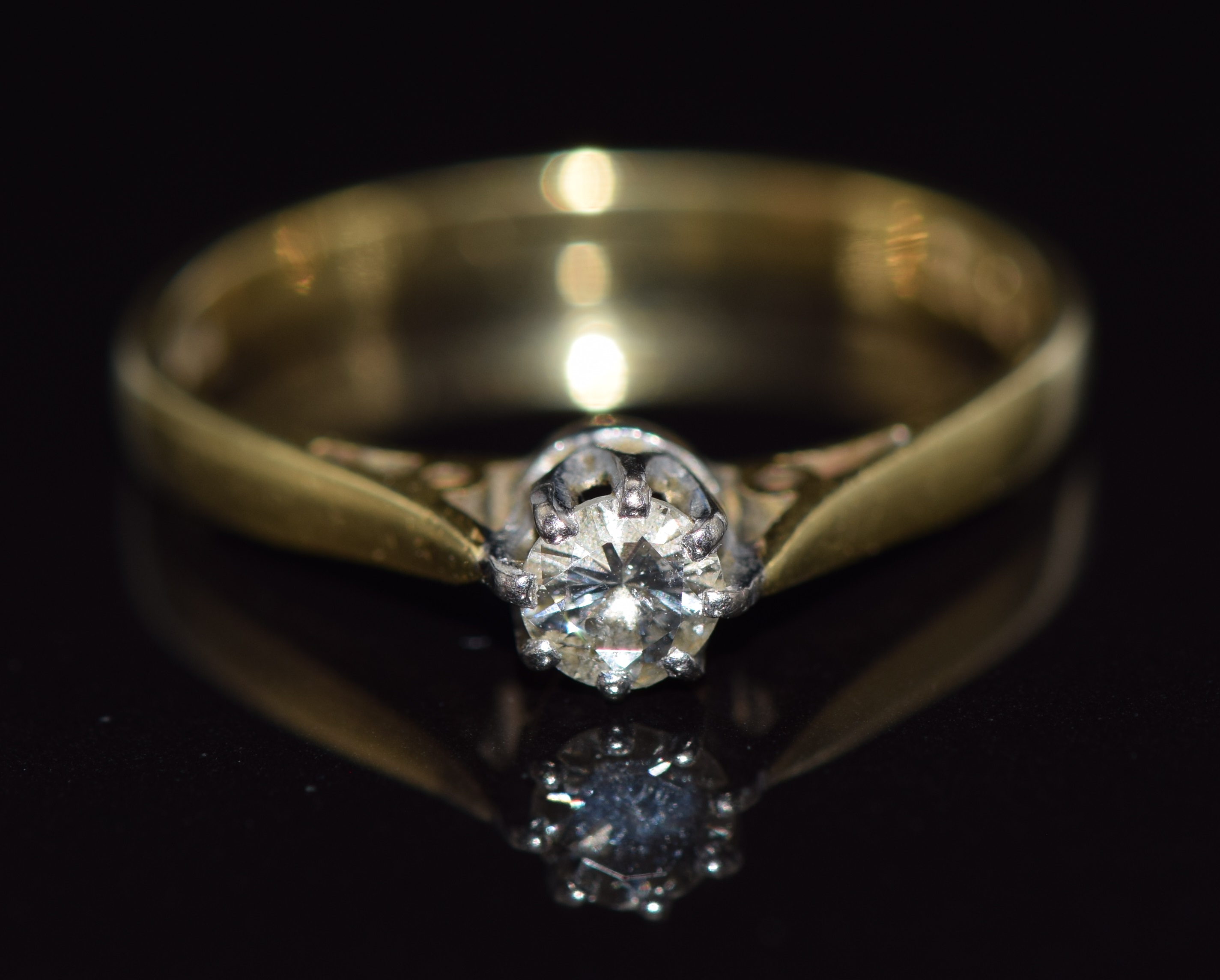 An 18ct gold ring set with a diamond of approximately 0.2ct, 2.4g, size M