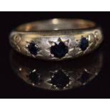 A 9ct gold ring set with sapphires in star settings, 3.7g, size M