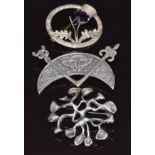 Three silver brooches, one in the form of a thistle by W B S, a Scottish silver example and one