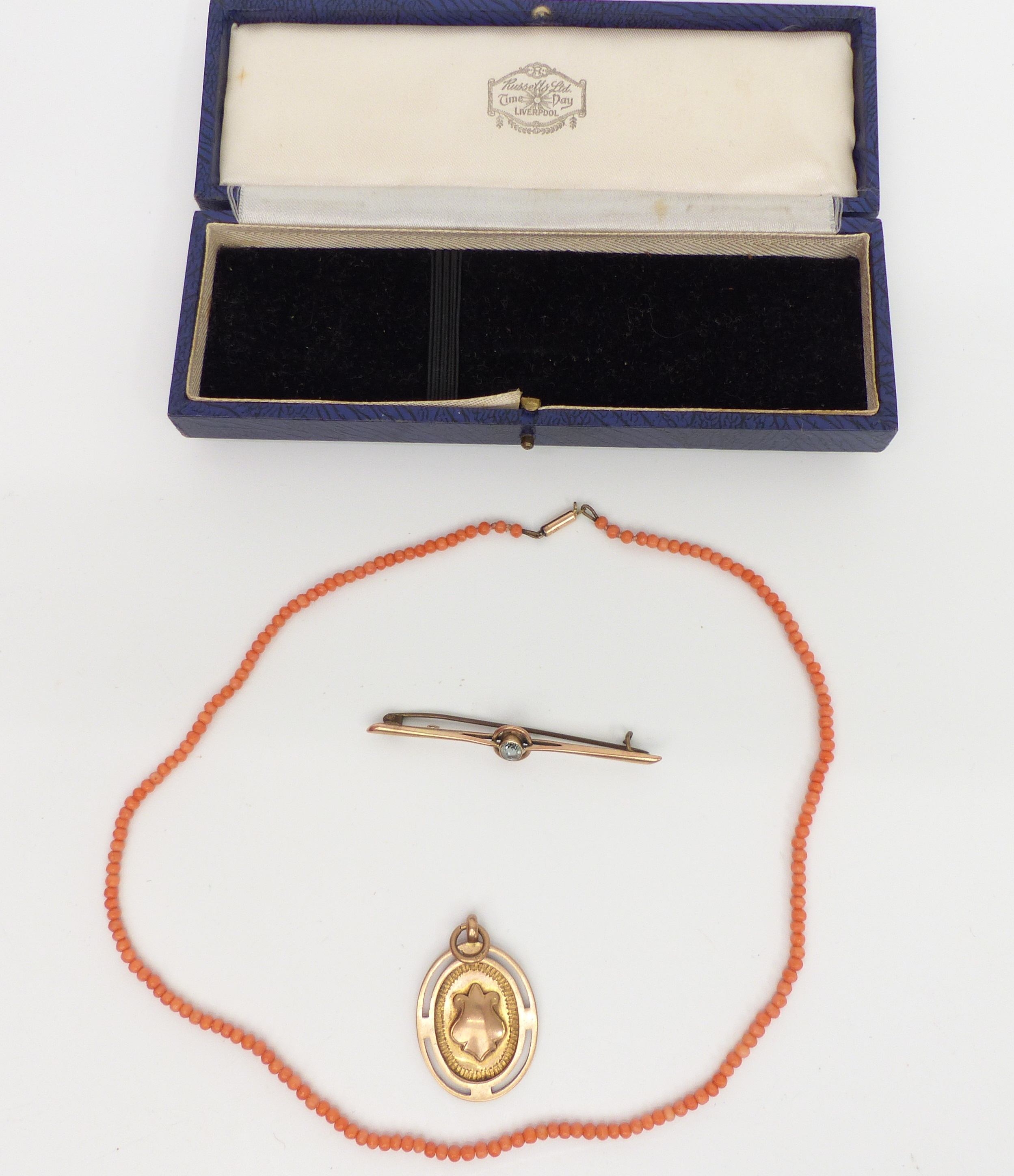 A 9ct gold fob, 9ct gold brooch (7.5g) and a coral necklace