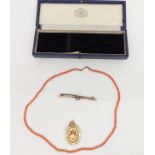 A 9ct gold fob, 9ct gold brooch (7.5g) and a coral necklace