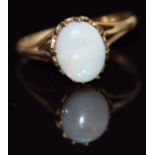 A 9ct gold ring set with an opal cabochon, 1.7g, size O