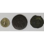 Greek bronze Ptolomy coin together with a Roman silver coin Empress, possibly Faustina, obverse, and