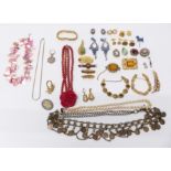 A collection of costume jewellery including silver brooch, silver ring set with a white sapphire,
