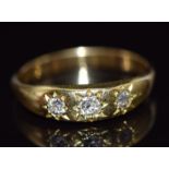 An 18ct gold ring set with three diamonds in a star setting, 3.3g, size N
